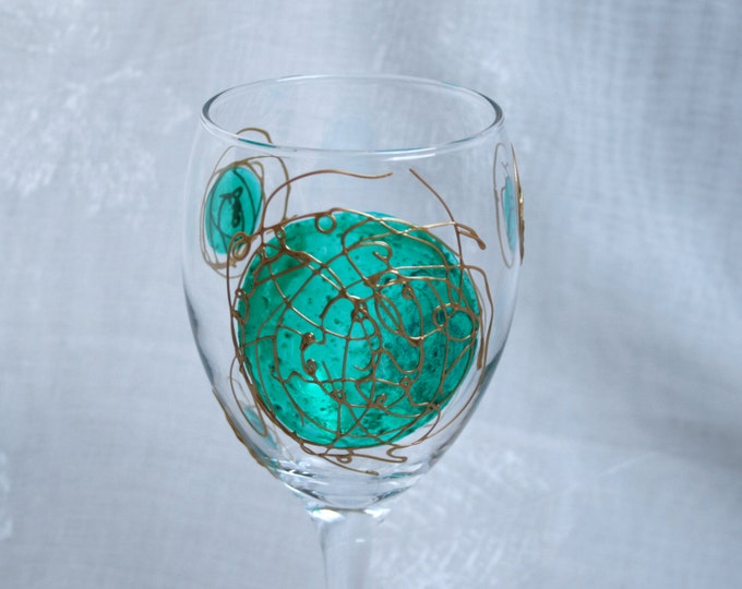 Galaxy - Green and Gold - An exclusive design, hand painted, wine glass featuring green  'planets' swirled with raised gold 'orbit trails'