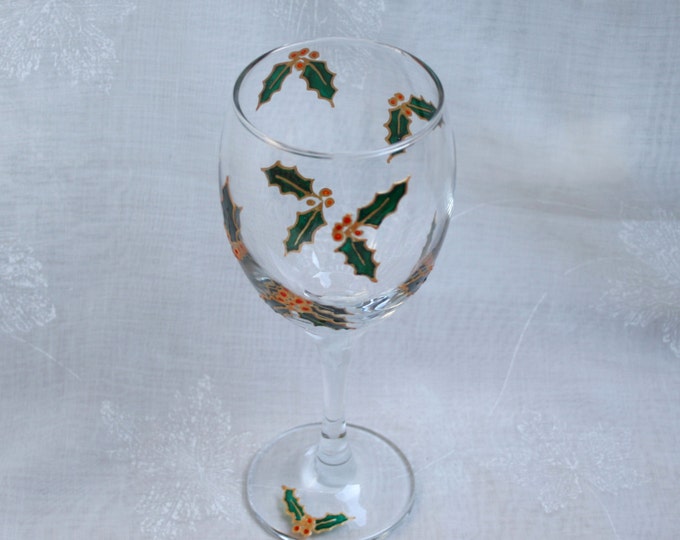 Holly Berry - An exclusive design, hand painted, wine glass featuring pairs of gold edged holly leaves and berries encircling the bowl.