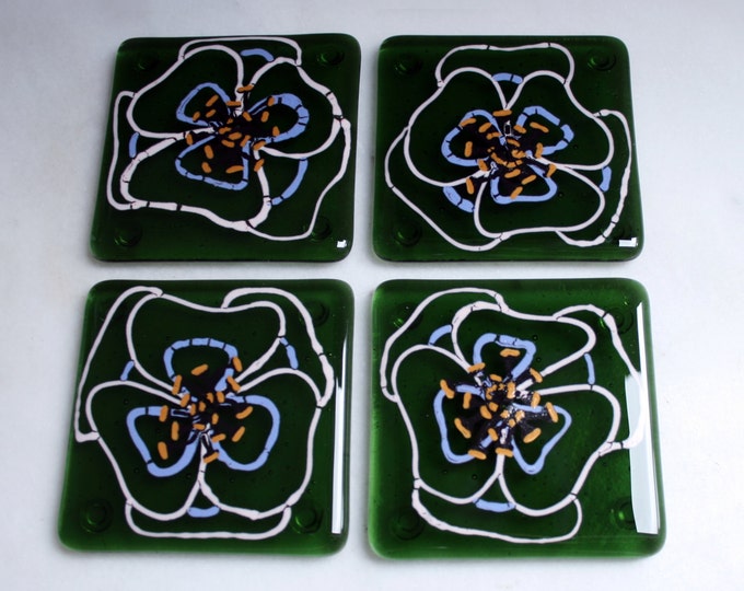Kiln Fused glass coasters. 'Viola'  Hand painted large pink and mauve flowers with black golden tipped stamens on an olive green glass base.