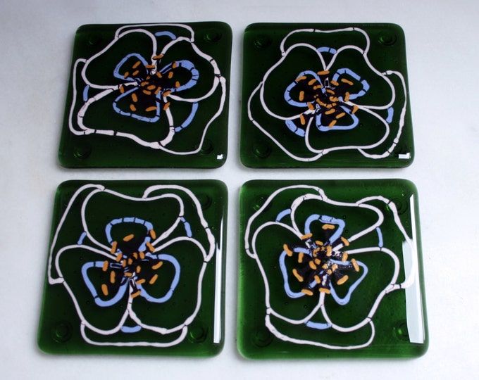 Kiln Fused glass coasters. 'Viola'  Hand painted large pink and mauve flowers with black golden tipped stamens on an olive green glass base.