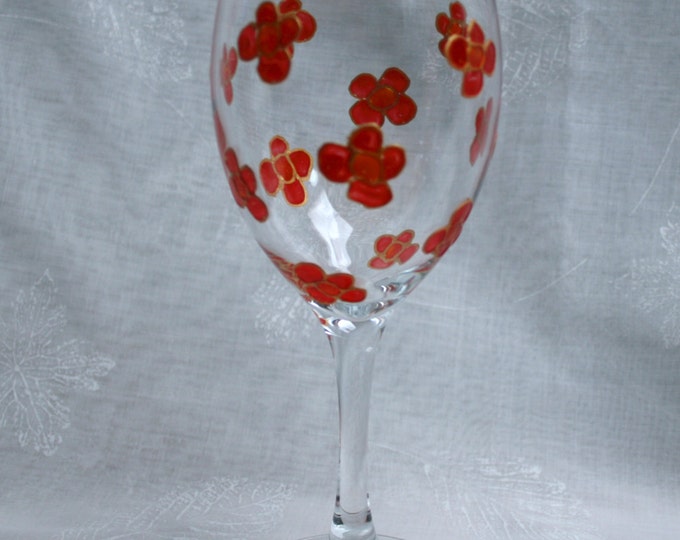 Blossom ~ Red & Gold. An exclusive design featuring a multitude of hand painted, red blossoms encasing a wine glass.