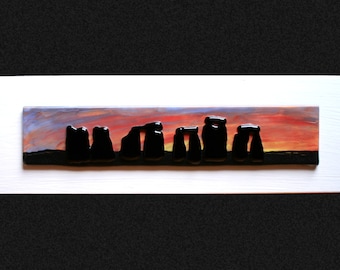 Stonehenge Sunset #1 Fused glass 'painting' raised 'stones' on a hand painted sunset background, set on a white frame. 34 x 10cm (13.5 x 4")