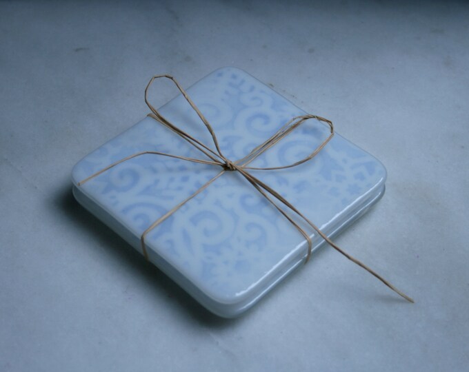 Fused glass. 'Jack Frost'  White snowflakes on pale blue. Ski chalet coasters. Winter holiday coasters. Christmas coasters. Choose 2 or 4.