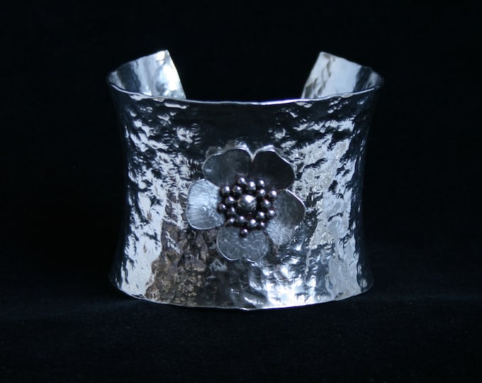 Wide anticlastic cuff bracelet. 'Wild Rose' Traditionally hand made with hammered finish for added sparkle. Fully UK Hallmarked Silver.