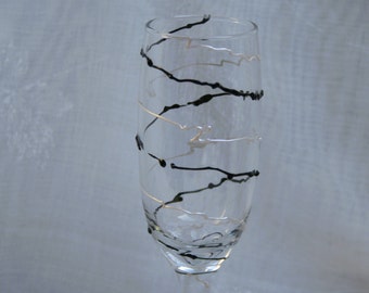 Spirali in Black and Pearl - An exclusive design, hand painted, spiral pattern in Black and Pearlescent white on a Champagne glass.
