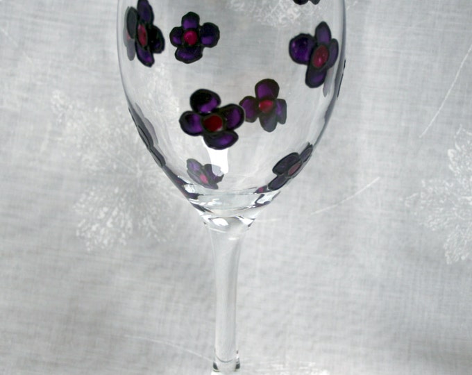 Blossom~ Purple. An exclusive design featuring a multitude of hand painted, purple blossoms encasing a wine glass.