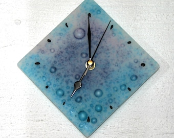 Ocean ~ A fused glass wall clock of turquoise & purple bubble glass that has been etched to resemble beach glass. Approx. 20 x 20cm (8 x 8")