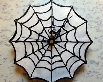 Gothic 'Wicked Webs'  wall clock - Spiderweb / Cobweb design, featuring a black web set upon a base of 3mm glass with a mottled white finish