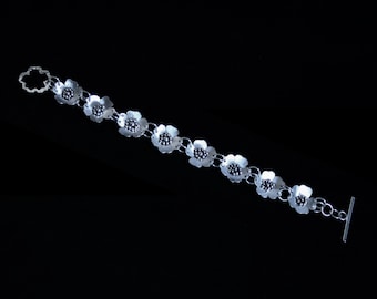 Exclusive 'Wild Rose' designer bracelet. Hand made with satin finish roses for subtlety. Fully UK Hallmarked Eco-friendly Sterling Silver.