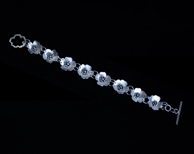 Exclusive 'Wild Rose' designer bracelet. Hand made with satin finish roses for subtlety. Fully UK Hallmarked Eco-friendly Sterling Silver.