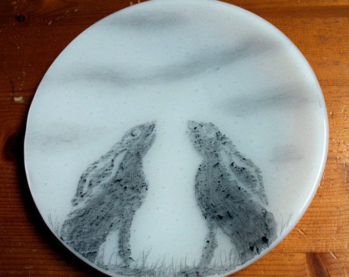 Fused glass trinket plate 'Moon-Gazing Hare' A pair of hares sihouetted against a full moon with wispy clouds. Approx. 19 cm / 7.5" diameter