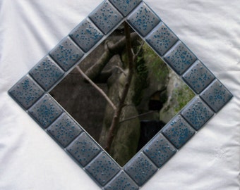 Reactions - A metallic pewter grey mirror with steel blue accents fused onto a clear base