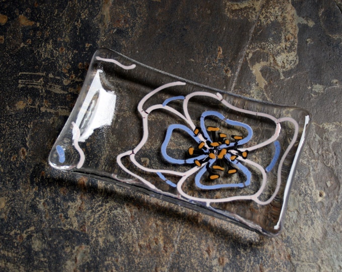 Viola ~  Fused glass soap / trinket / chocolates dish. A hand painted Pink & Mauve flower with gold tipped black stamens on a clear base.