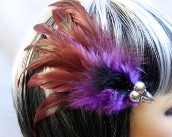 Exclusive 'Purple plus Raven' hair grip / fascinator in Purple and pinky red, with hints of green and a center of black.