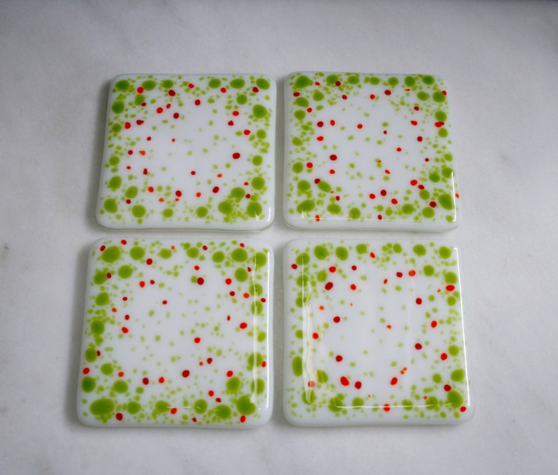 Handmade fused art glass coasters. 'Cosmic Horizons Spring blossoms' Green, red and orange on a white base. Choose a pair or a set of 4. image 2