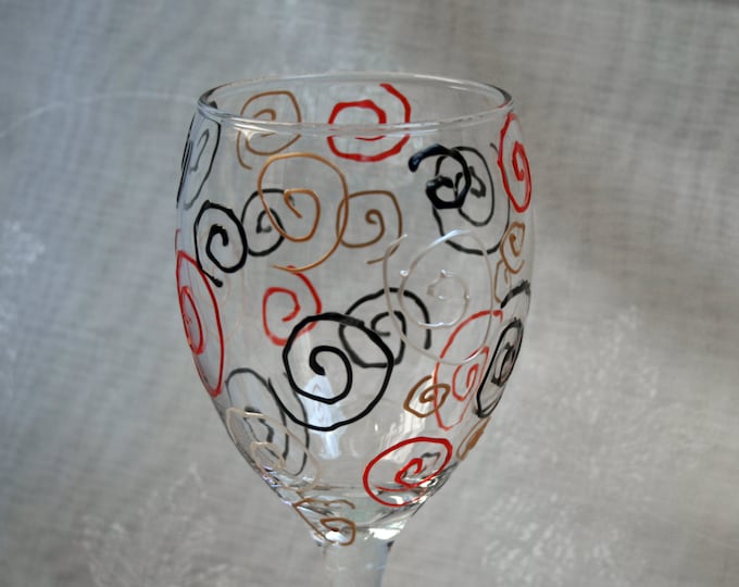 Eternal Spiral - An exclusive design, hand painted, wine glass featuring a multitude of spirals in Red, Black, Gold and Silver