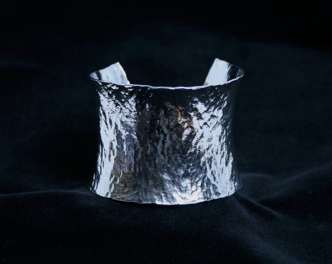 Wide anticlastic cuff bracelet. 'Lynda' Traditionally hand made with hammered finish for added sparkle. Fully UK Hallmarked Sterling Silver.