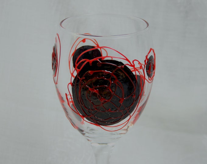 Galaxy - Black and Red - An exclusive design, hand painted, wine glass featuring black  'planets' swirled with raised red 'orbit trails'