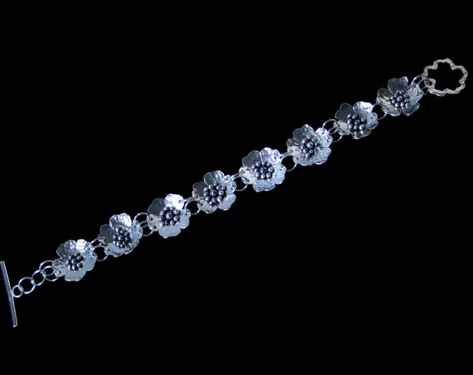 Exclusive 'Wild Rose' floral bracelet. Hand made with hammered roses for added sparkle. Fully UK Hallmarked Eco-friendly Sterling Silver.