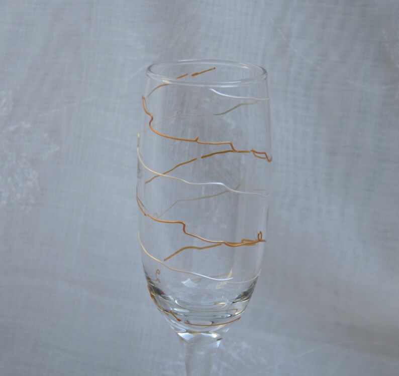 Spirali in Gold and Pearl An exclusive design, hand painted, spiral pattern in Gold and Pearlescent white on a Champagne glass. image 2