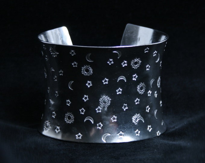 Wide anticlastic cuff bracelet 'Sun, Moon and Stars' Traditionally hand made with hand stamped pattern. Fully UK Hallmarked Sterling Silver.