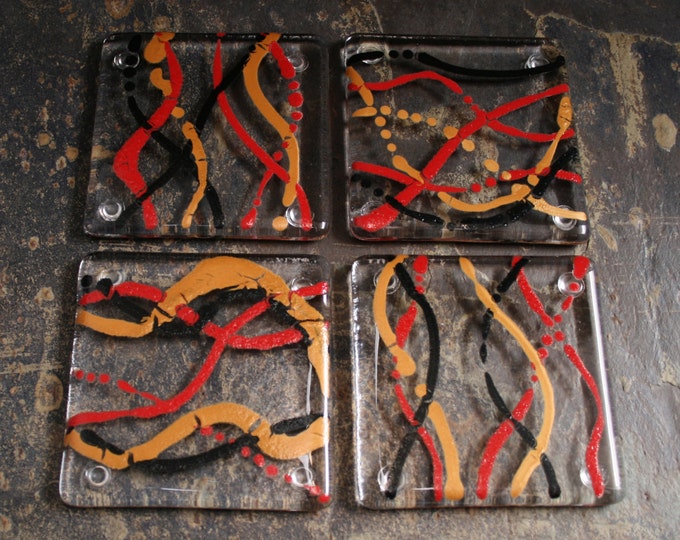 Fused glass coasters. 'Serpentine - Inferno'  Black, red and Gold on a clear base. Squiggly coasters. Choose 2 or 4. Can be customized.