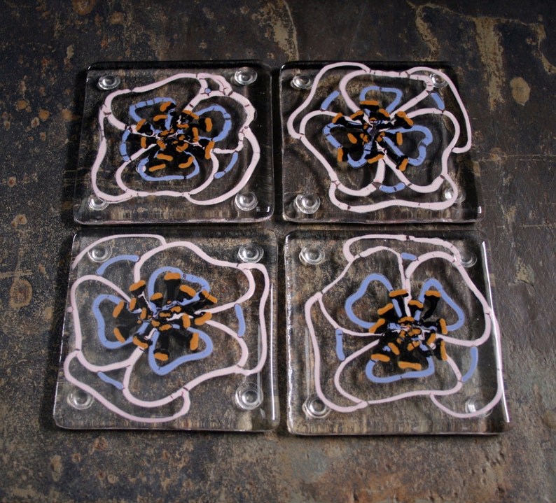 Kiln Fused glass coasters. 'Viola' Hand painted large pink and mauve flowers with black golden tipped stamens on a clear glass base. image 1