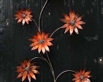 Copper flowers - a wall hanging spray of multi-hued copper flowers.