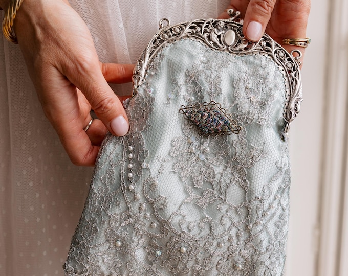 Antique  silver    (800) frame remade in vintage style beaded lace over pale blue silk.