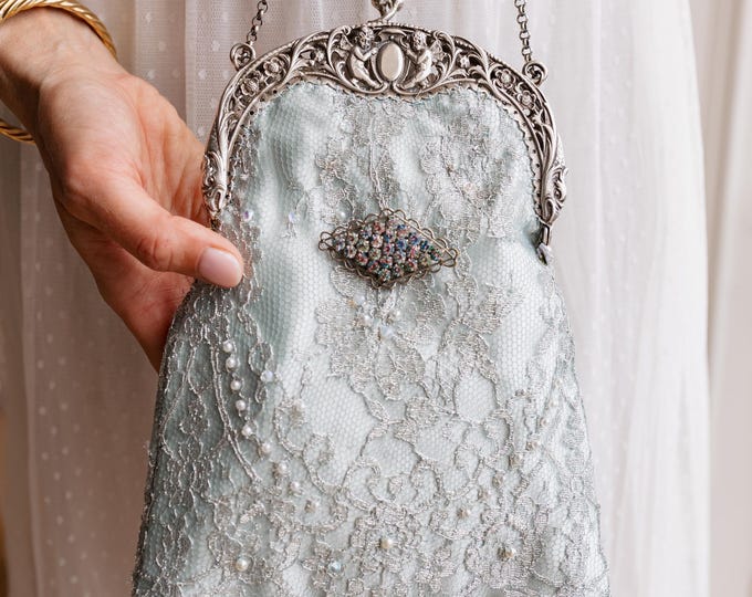 Antique  silver    (800) frame remade in vintage style beaded lace over pale blue silk.