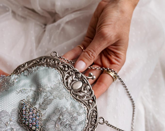 Antique  silver    (800) frame remade in vintage style beaded lace over pale blue silk.