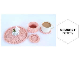 May include: A set of three pink crocheted coasters, one large enough to hold a small potted plant, and two smaller ones for cups. The coasters have a delicate, lacy design and are perfect for adding a touch of handmade charm to your home.
