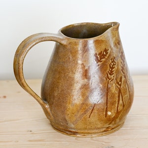 Ceramic pitcher, hand-thrown in stoneware, golden brown with hand-painted wheat motif on two sides. image 1