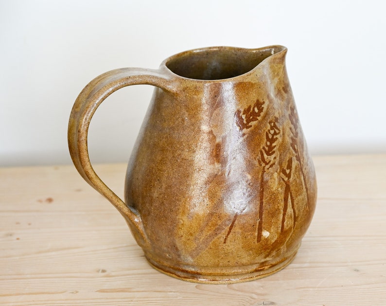Ceramic pitcher, hand-thrown in stoneware, golden brown with hand-painted wheat motif on two sides. image 1
