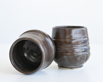 A pair of ceramic tumblers, handmade and glazed in a satin deep blue denim