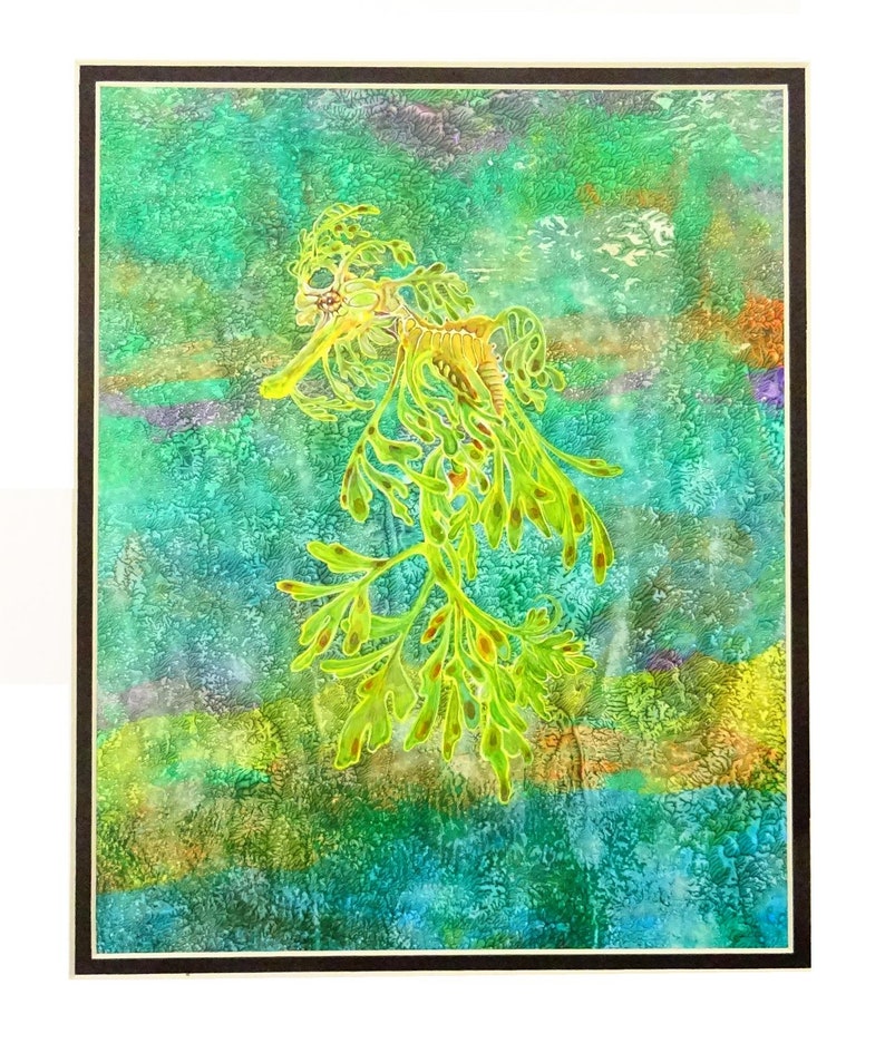 May include: A colourful watercolour painting depicting a leafy seadragon. The seadragon is a vibrant lime green and yellow, with detailed features. The background is a textured mix of blues, greens, and yellows, evoking an underwater scene.