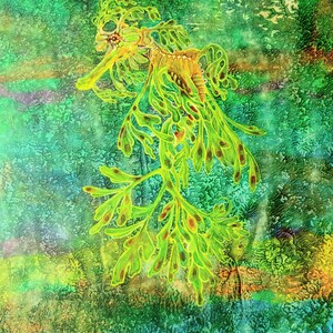 May include: A detailed illustration of a leafy seadragon, set against a textured backdrop of greens and blues. The seadragon is depicted in bright green with brown markings, its body adorned with leaf-like appendages. The artwork has a watercolour effect.