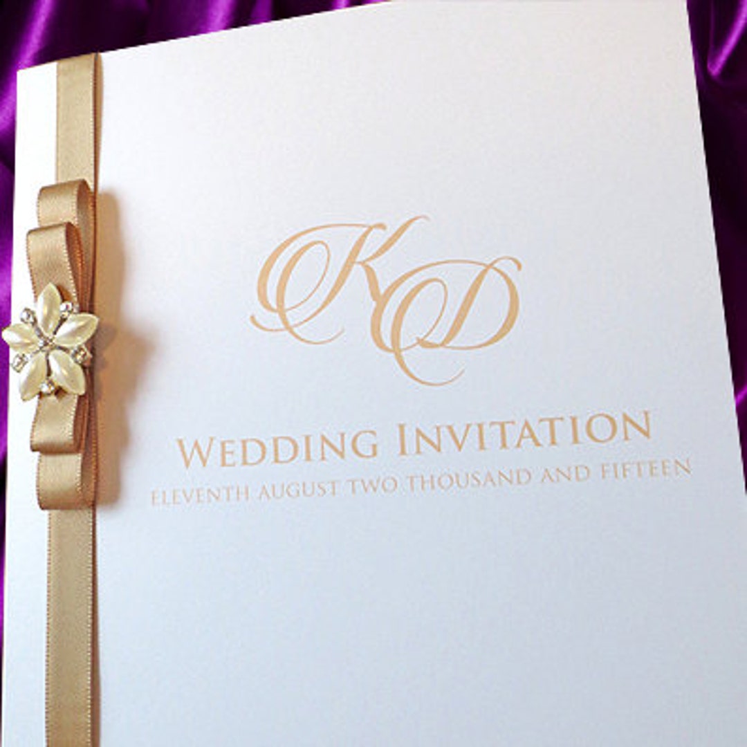 Classic folded invitation with gold dior bow.