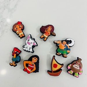 May include: A collection of colorful cartoon character charms, including a girl with a red flower, a pig, a rooster, a woman in a red dress, a boat, a man with a hook, a man with a club, and a creature with green leaves.