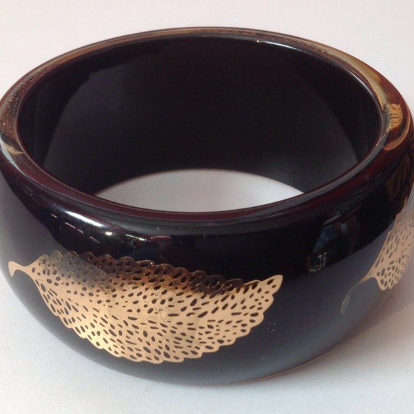 Bangle bracelet with gold leaf design
