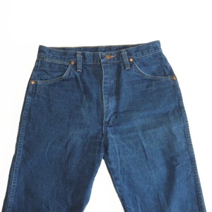 May include: A pair of blue denim jeans with a high waist and a classic straight leg fit.
