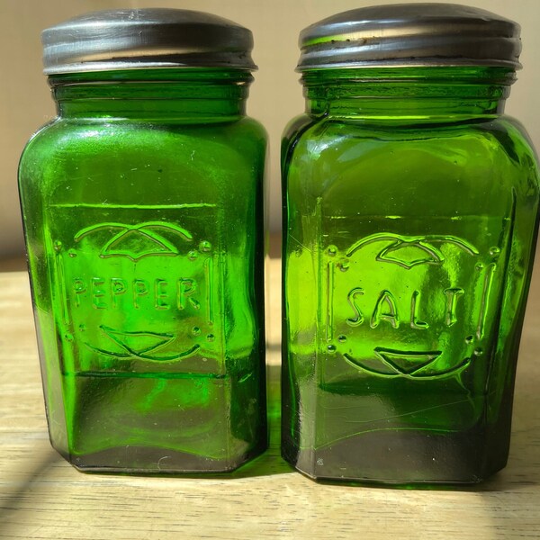 Green Glass Salt & Pepper Embossed Shakers. Large shaker pair are reproductions of Depression Era Hazel Atlas bottles from the 1930s.