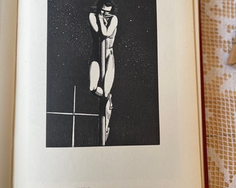 May include: Black and white wood engraving of a person standing on a mast, looking down, with a starry night sky in the background. The title "Rockwell Kent: Mast-Head" and the text "Wood-Engraving 8 x 5 1/2 inches" are printed below the image.