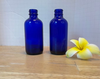 Cobalt Blue Glass Bottle Pair. Ribbed & numbered on bottoms. Fitted with corks since screw tops are gone. 4-1/2" h x 1-3/4" diam. each.