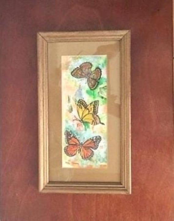 Vintage Butterfly Painting. Framed under glass & ready to hang. These cheerful creatures appear in vibrant colors. Signed by the artist.