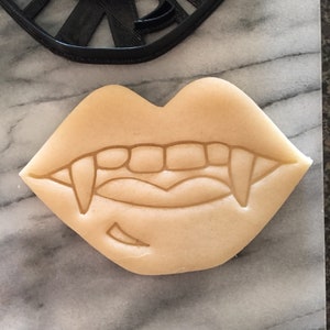 May include: A set of three ceramic nesting bowls with a speckled, off-white glaze. The bowls vary in size, with the largest measuring approximately 6 inches in diameter. Each bowl has a rounded shape and a simple, minimalist design.