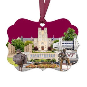 May include: A maroon and gold Christmas ornament featuring a depiction of the Virginia Tech campus, including the iconic Burruss Hall, a statue of a turkey, and a statue of a football player. The ornament also features the Virginia Tech logo.