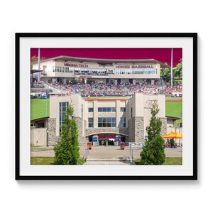 May include: Framed print of the Virginia Tech Hokies Baseball stadium. The image shows the stadium exterior with the words "Virginia Tech" and "Hokies Baseball" visible. The stadium is filled with spectators.
