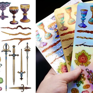 May include: A collection of stickers featuring various mystical and fantasy-themed illustrations. The stickers include chalices, wands, swords, and decorative floral and geometric elements in a variety of colors, including gold, blue, and purple.