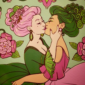 May include: Two women in elaborate dresses with pink and green floral details are kissing. The woman on the left has pink hair and a green dress, while the woman on the right has green hair and a pink dress. They are surrounded by green vines and pink flowers.